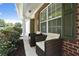 Covered front porch with two chairs featuring brick accent wall and pillars at 8237 Eastshore Dr, Union City, GA 30291