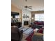 Carpeted living room featuring fireplace, ceiling fan, and a large window for natural light at 8237 Eastshore Dr, Union City, GA 30291