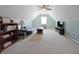 Finished attic featuring a seating area, TV, and carpeted floors at 942 Fairmont Park Dr, Dacula, GA 30019