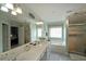 Bright bathroom featuring double sink vanity, separate shower, and large soaking tub at 942 Fairmont Park Dr, Dacula, GA 30019