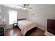 Bedroom featuring hardwood floors and a large window, providing plenty of natural light at 942 Fairmont Park Dr, Dacula, GA 30019