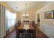 Elegant dining room with a wooden table, chandelier, and ample natural light at 942 Fairmont Park Dr, Dacula, GA 30019