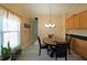 Bright dining area features a large window, chandelier and wood table with four chairs at 942 Fairmont Park Dr, Dacula, GA 30019