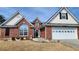 Beautiful brick house with white trim, a two-car garage, and manicured landscaping, creating a welcoming curb appeal at 942 Fairmont Park Dr, Dacula, GA 30019