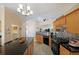 Bright kitchen with stainless steel appliances, tile backsplash, island with barstool seating and pendant lighting at 942 Fairmont Park Dr, Dacula, GA 30019