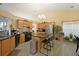 Bright kitchen with stainless steel appliances, tile backsplash, island with barstool seating and pendant lighting at 942 Fairmont Park Dr, Dacula, GA 30019