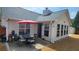 Outdoor patio with a dining set, surrounded by lush greenery, providing a serene space for relaxation and dining at 942 Fairmont Park Dr, Dacula, GA 30019