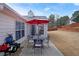 Outdoor patio with a table, seating, and view of the spacious, fenced backyard at 942 Fairmont Park Dr, Dacula, GA 30019