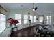 Light-filled sunroom with hardwood floors and built-in bench seating beneath a series of windows at 942 Fairmont Park Dr, Dacula, GA 30019