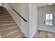 A carpeted staircase leading to the upper level sits beside the entryway with luxury vinyl plank flooring at 4604 Eastbrook Pl, Snellville, GA 30039