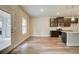 Eat-in kitchen featuring wood-look flooring, brown cabinets and stainless steel appliances at 4604 Eastbrook Pl, Snellville, GA 30039