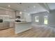 Well-lit kitchen boasts gray cabinets, granite countertops, and stainless steel appliances at 4604 Eastbrook Pl, Snellville, GA 30039