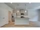 Bright kitchen featuring gray cabinets, a center island, and stainless steel appliances at 4604 Eastbrook Pl, Snellville, GA 30039