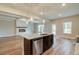 Open concept kitchen with stainless steel appliances, granite countertops, and a center island overlooking the living area at 4604 Eastbrook Pl, Snellville, GA 30039