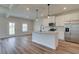 Modern kitchen with white cabinets, stainless steel appliances, and center island sink at 4604 Eastbrook Pl, Snellville, GA 30039