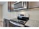 Close-up of a kitchen showcasing stainless steel appliances and granite countertops at 4604 Eastbrook Pl, Snellville, GA 30039