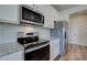 Bright kitchen with white cabinets, stainless steel appliances, and granite countertops, perfect for cooking and entertaining at 4604 Eastbrook Pl, Snellville, GA 30039