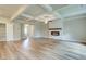 Open concept living room featuring wood look floors, a coffered ceiling and fireplace at 4604 Eastbrook Pl, Snellville, GA 30039