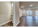 Living room with a half bath, dark wood floors, can lighting, and a picture window at 4604 Eastbrook Pl, Snellville, GA 30039