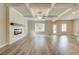 Spacious open-concept living room features an electric fireplace, coffered ceilings, and luxury vinyl plank flooring at 4604 Eastbrook Pl, Snellville, GA 30039