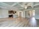 Open-concept living room boasts luxury vinyl plank flooring, coffered ceilings, and dark cabinetry at 4604 Eastbrook Pl, Snellville, GA 30039