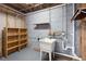 Basement laundry area with utility sink and shelves at 6464 Westerly Way, Douglasville, GA 30135