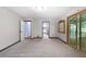 Spacious bedroom featuring neutral paint, carpet, and a sliding door to the screened-in back porch at 6464 Westerly Way, Douglasville, GA 30135