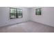 Bedroom with neutral paint, carpet, and two windows at 6464 Westerly Way, Douglasville, GA 30135