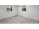 Bedroom featuring neutral paint, carpet, and two windows at 6464 Westerly Way, Douglasville, GA 30135