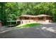 Exterior view of brick home with mature trees and large driveway at 6464 Westerly Way, Douglasville, GA 30135