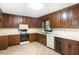 Well-lit kitchen equipped with wooden cabinets, and a variety of appliances at 6464 Westerly Way, Douglasville, GA 30135