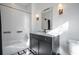 Bathroom featuring white subway tile in the shower, a vanity with a marble top and black and white tile floors at 77 Krog Ne St, Atlanta, GA 30307