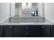 Stylish bathroom features a double vanity with marble countertops, dark cabinetry, and decorative mirrors at 77 Krog Ne St, Atlanta, GA 30307