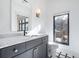 Bathroom featuring a marble vanity top, black hardware and black and white tiled flooring at 77 Krog Ne St, Atlanta, GA 30307