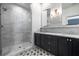 Bathroom featuring a glass-enclosed shower, dark cabinetry with marble countertops, and modern fixtures at 77 Krog Ne St, Atlanta, GA 30307