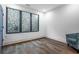 Bright bedroom featuring modern windows, hardwood floors, and a contemporary armchair at 77 Krog Ne St, Atlanta, GA 30307