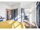 Bright bedroom featuring gray doors, hardwood floors, and an ensuite bathroom with black and white tile at 77 Krog Ne St, Atlanta, GA 30307