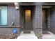 Brick entryway showcasing modern door with sidelight, protected by an ADT security system at 77 Krog Ne St, Atlanta, GA 30307