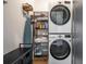 Convenient laundry area with stacked washer and dryer units and built-in shelving for storage at 77 Krog Ne St, Atlanta, GA 30307