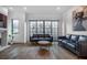 Bright living room featuring hardwood floors, modern fireplace, and access to backyard at 77 Krog Ne St, Atlanta, GA 30307