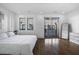 Bright main bedroom features hardwood floors, and modern fixtures with a sliding glass door leading to a private balcony at 77 Krog Ne St, Atlanta, GA 30307