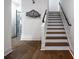 Modern stairway with hardwood treads and sleek black handrail leading to upper levels at 77 Krog Ne St, Atlanta, GA 30307