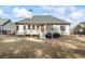 Back exterior view featuring a deck, patio, grill, and manicured lawn at 9620 Coastal Pointe Dr, Villa Rica, GA 30180