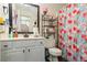 Bathroom featuring a patterned shower curtain, vanity with mirror, and open shelving for storage at 9620 Coastal Pointe Dr, Villa Rica, GA 30180