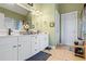 Bathroom featuring double sinks, white cabinets, and neutral tile for a relaxing atmosphere at 9620 Coastal Pointe Dr, Villa Rica, GA 30180