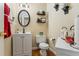 Charming half bathroom with updated vanity, oval mirror, and stylish decor for a modern feel at 9620 Coastal Pointe Dr, Villa Rica, GA 30180