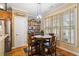 Cozy breakfast nook with a round wood table and shelving filled with decorative items next to a large window at 9620 Coastal Pointe Dr, Villa Rica, GA 30180