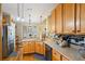 Kitchen with honey colored cabinets, sleek countertops and view to the breakfast nook at 9620 Coastal Pointe Dr, Villa Rica, GA 30180