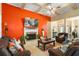 Cozy living room featuring a fireplace, accent wall, and hardwood floors at 9620 Coastal Pointe Dr, Villa Rica, GA 30180