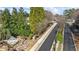 A scenic street view of a community entrance featuring lush greenery and stone accents at 9620 Coastal Pointe Dr, Villa Rica, GA 30180